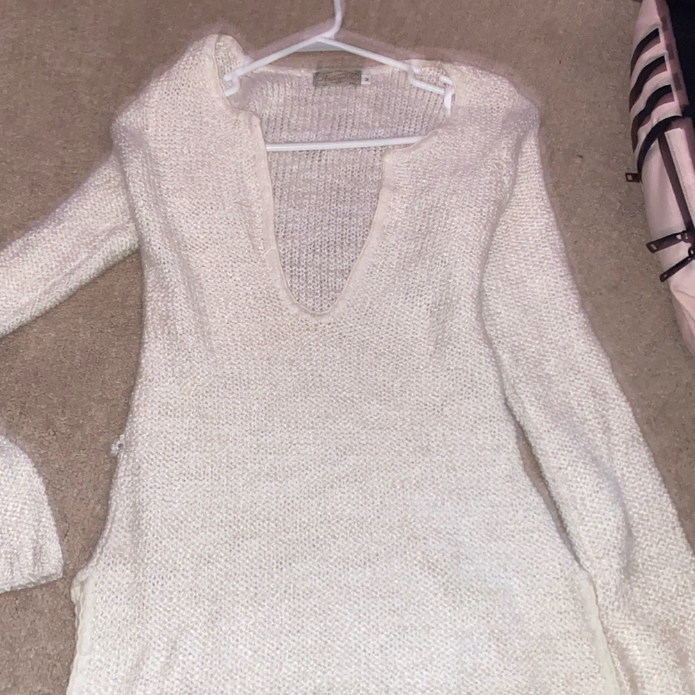 white sweater there is a hole on the left side.